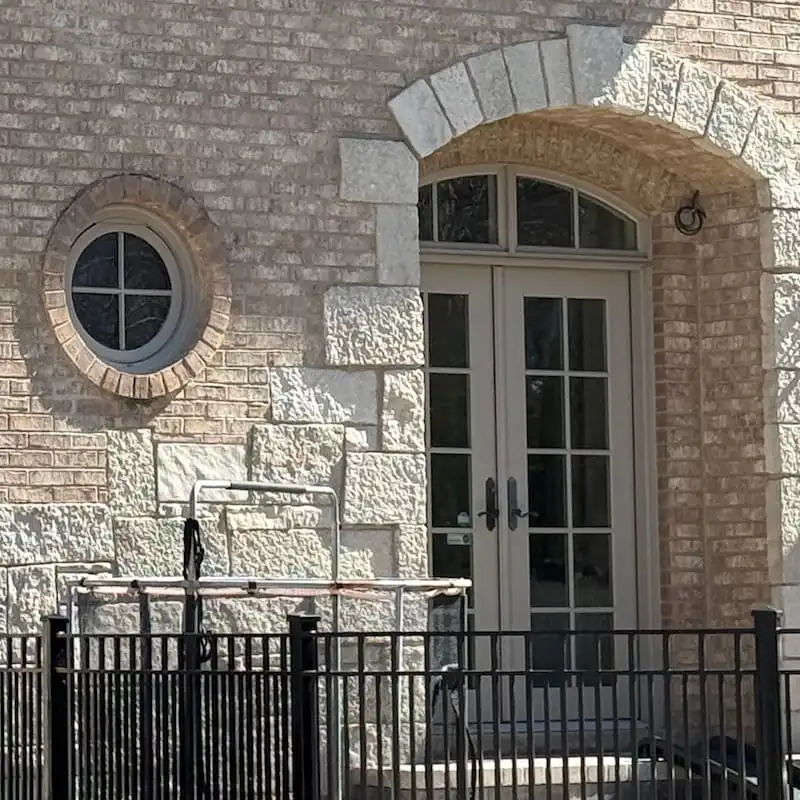 Stone wall with round window and doors in Arlington Heights, IL.